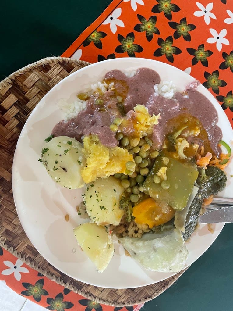 A real buffet plate from Afrika Bite — rice, beans in sauce, potatoes, peas, and vegetables